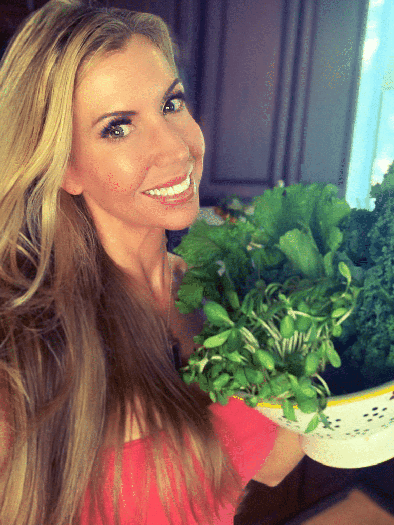 Andrea Cox with colander of fresh herbs