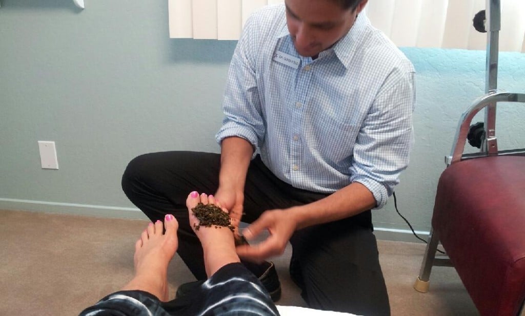 My broken foot being packed with comfrey, an ancient ayervedic tradition